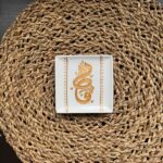 A glass magnet with a "Qatar" design